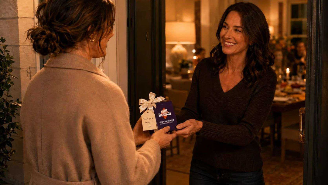 Two woman exchanging a hostess gift Old Fashioned at a door